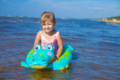 Cute girl swimming in sea