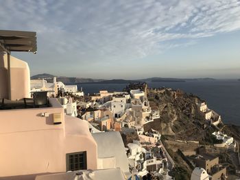 High angle view of townscape by sea against sky