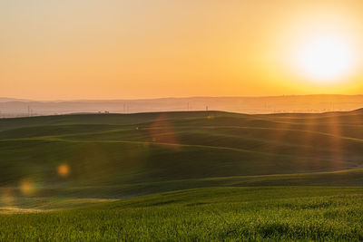 Scenic view of field against sky during sunset