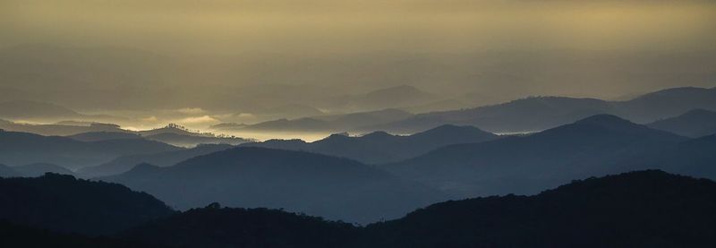 Scenic view of mountains against sky at sunset