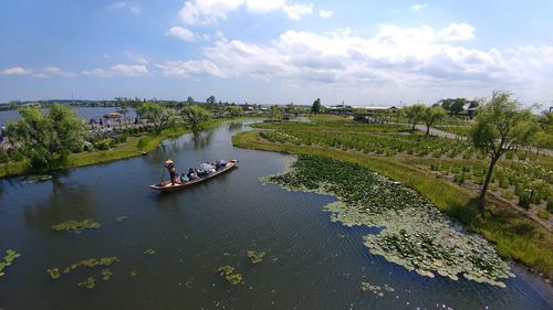 High angle view of river amidst trees against sky