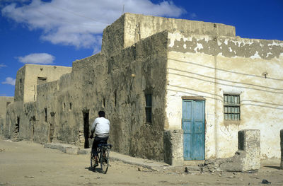 Rear view of man walking on street