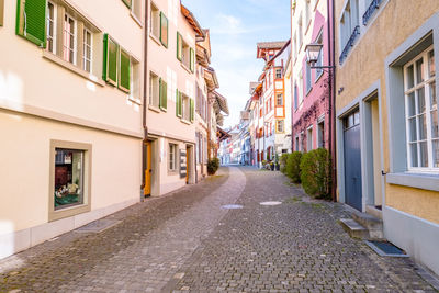 Street amidst buildings against sky