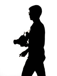 Side view of silhouette woman against white background