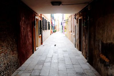 Empty alley amidst buildings in city