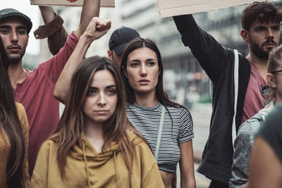 Group of protestors with their signs raised up in the air. activists protesting on the street.