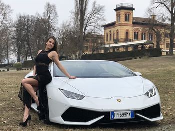 Full length portrait of woman in car