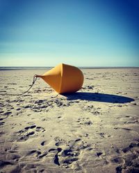 Scenic view of beach against clear blue sky