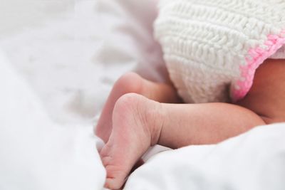Close-up of baby feet on bed