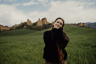 Portrait of woman standing on field