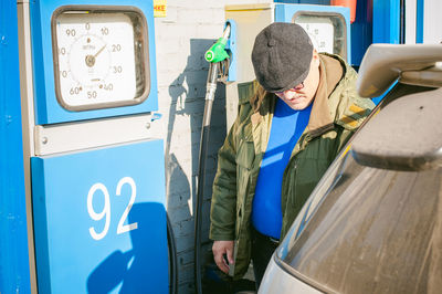 Man filling fuel in car