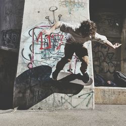 Full length of woman standing on wall