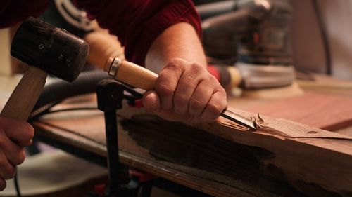 Midsection of man working in workshop