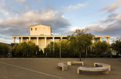 Empty park by building against sky