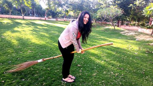 Full length portrait of young woman in park