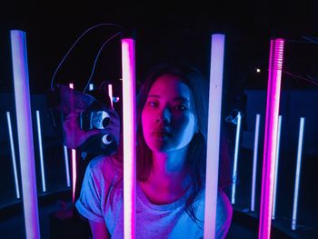 Portrait of woman in illuminated nightclub