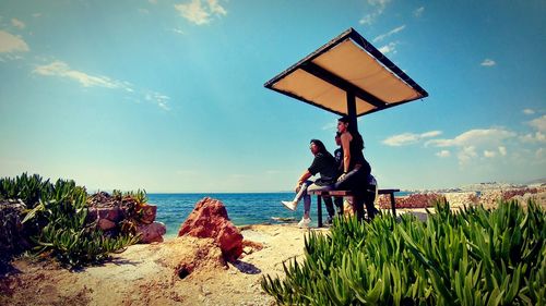 Built structure on beach against sky