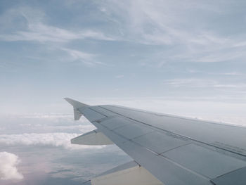 Airplane flying over clouds in sky