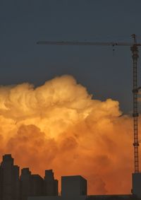 Low angle view of silhouette buildings against sky during sunset