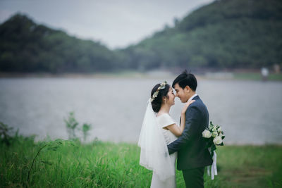 Rear view of couple standing by plants