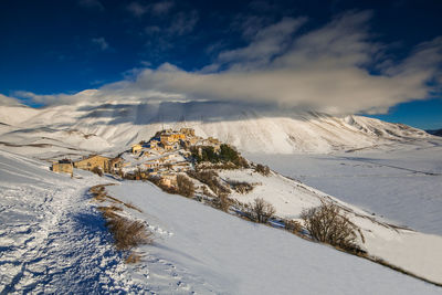 Scenic view of snow covered mountains against sky