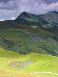 Scenic view of mountain against cloudy sky