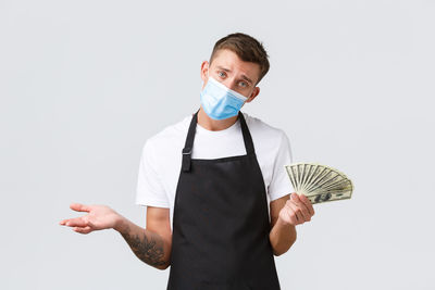 Portrait of man standing against white background