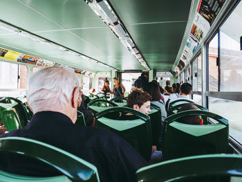 Rear view of people traveling in bus