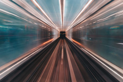 Blurred motion of train at railroad station