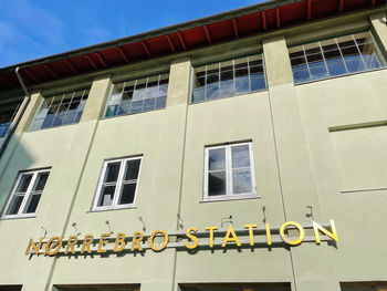 Low angle view of yellow building against sky