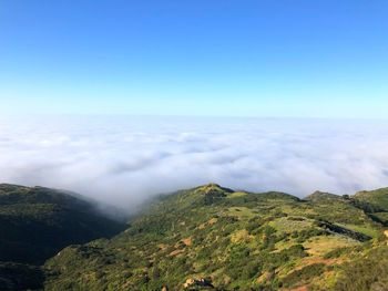 Scenic view of mountains against blue sky