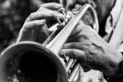 Midsection of man playing cornet