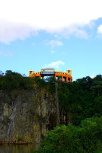 Built structure by trees against sky