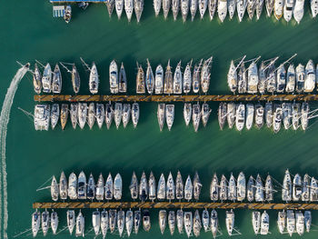 Marina top down aerial view boat sailing off