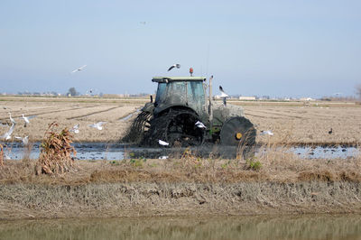 Plowing rice field with tractor