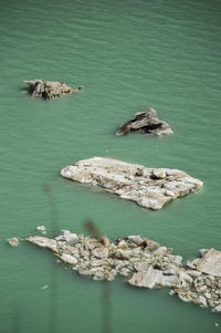 High angle view of rocks in sea