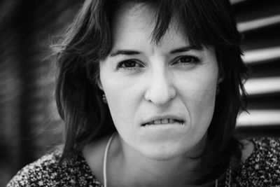 Sad young woman close-up face, outdoors portrait