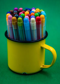 Close-up of multi colored drinking straws in container