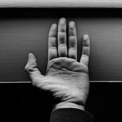 Close-up of human hand on wall