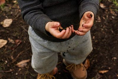 Low section of baby boy with dirty hands