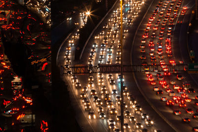 High angle view of illuminated vehicles on road at night