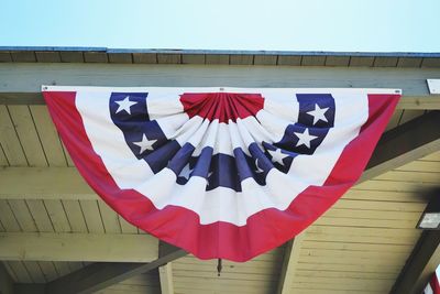 Low angle view of flag hanging from porch