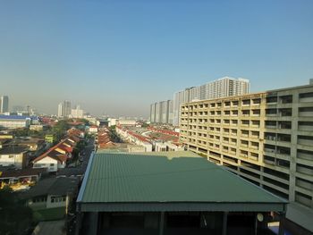 High angle view of buildings against clear blue sky