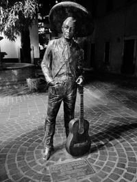 Full length portrait of a man holding guitar