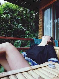 Midsection of man sitting in yard