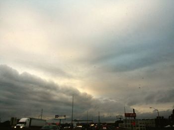 Buildings against cloudy sky