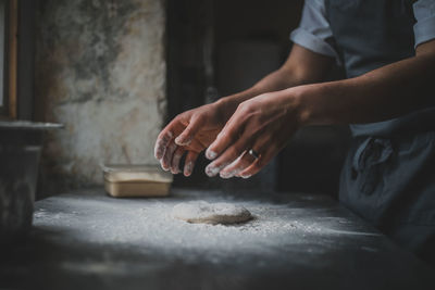 Midsection of man preparing food in kitchen