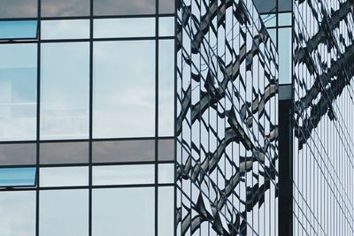 Close-up of modern office building against sky