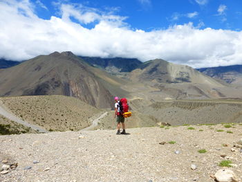 Man standing on mountain against sky