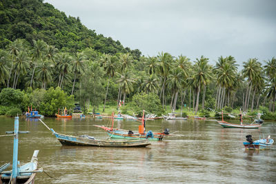 Boats in sea against mountain